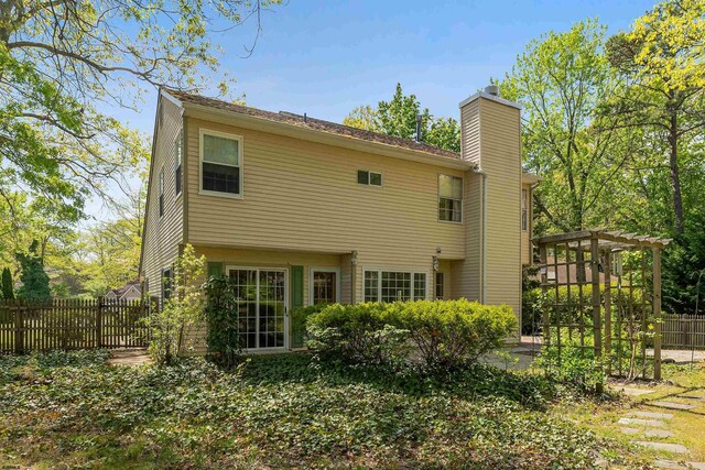 711 Falcon Crest Pl, Smithville, NJ 08205 - rear view of house featuring a chimney, fence, and a patio