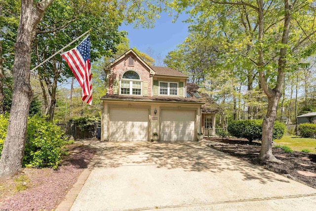 711 Falcon Crest Pl, Smithville, NJ 08205 - traditional-style house featuring an attached garage, fence, and driveway