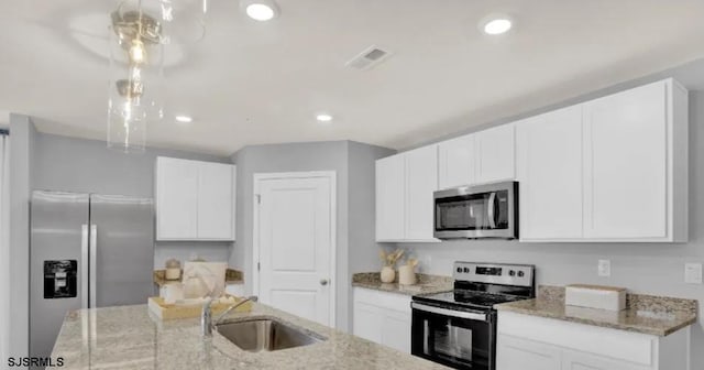 122 Hilton Ct, Egg Harbor Township, NJ 08234 - kitchen with appliances with stainless steel finishes, a sink, white cabinets, light stone counters, and hanging light fixtures