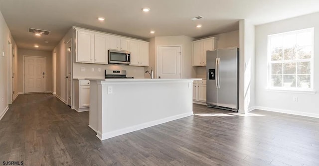 122 Hilton Ct, Egg Harbor Township, NJ 08234 - kitchen featuring appliances with stainless steel finishes, dark wood-style floors, a kitchen island with sink, baseboards, and light countertops