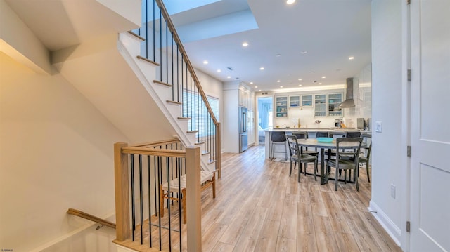 interior space featuring light wood-style floors, stairway, and recessed lighting