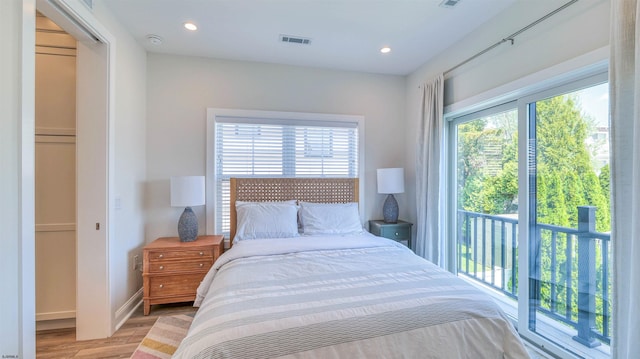 bedroom with visible vents, recessed lighting, light wood-style floors, and multiple windows