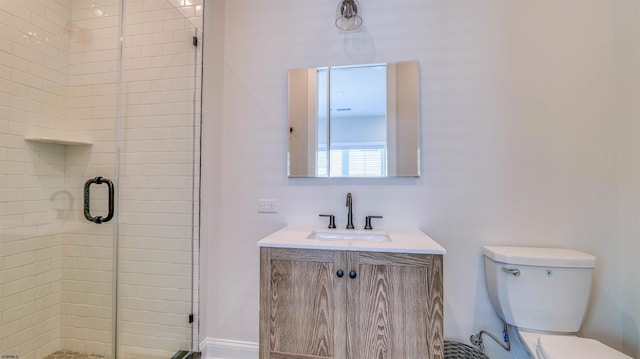 bathroom with vanity, toilet, and a shower stall