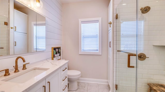 full bath with vanity, toilet, plenty of natural light, and a stall shower