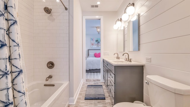 bathroom featuring shower / tub combo with curtain, vanity, toilet, and visible vents