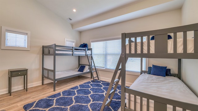 bedroom with visible vents, wood finished floors, baseboards, lofted ceiling, and recessed lighting