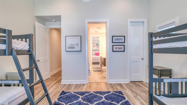 bedroom with baseboards and wood finished floors