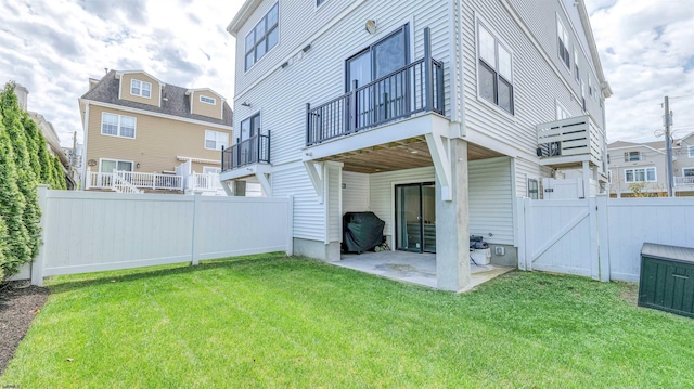 back of house with a patio, a gate, a fenced backyard, and a yard