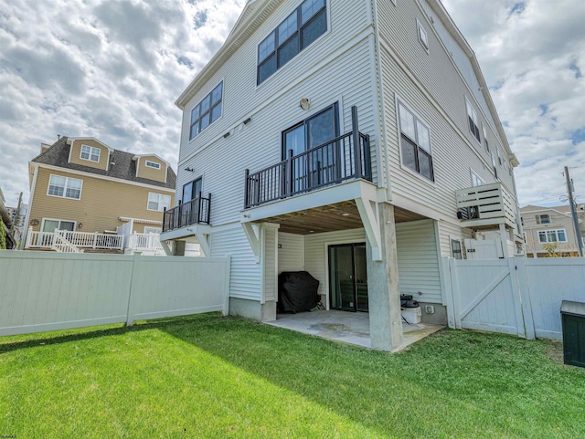 back of property featuring a patio, a gate, fence, and a yard