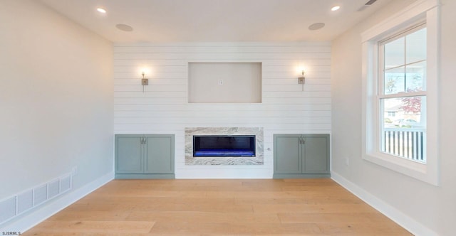 933 Oak Grv, Linwood, NJ 08221 - unfurnished living room featuring a high end fireplace, baseboards, light wood-type flooring, and visible vents