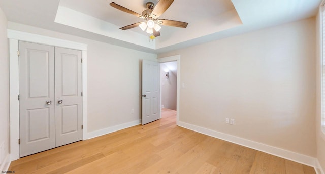 933 Oak Grv, Linwood, NJ 08221 - unfurnished bedroom featuring baseboards, a raised ceiling, ceiling fan, and light wood-type flooring