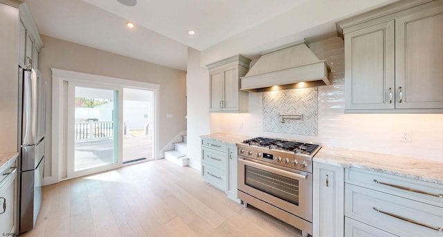 933 Oak Grv, Linwood, NJ 08221 - kitchen featuring light stone countertops, light wood-style flooring, premium range hood, stainless steel appliances, and tasteful backsplash