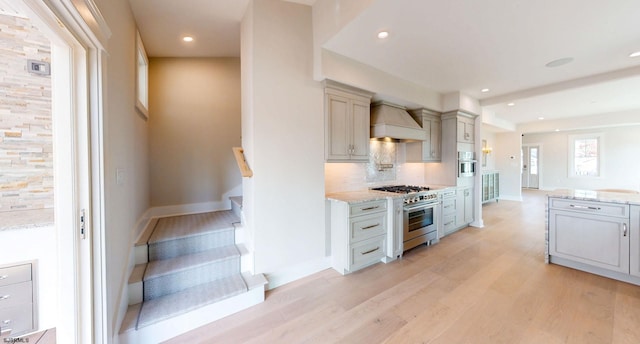 933 Oak Grv, Linwood, NJ 08221 - kitchen with decorative backsplash, custom exhaust hood, light wood-style floors, light stone counters, and stainless steel appliances