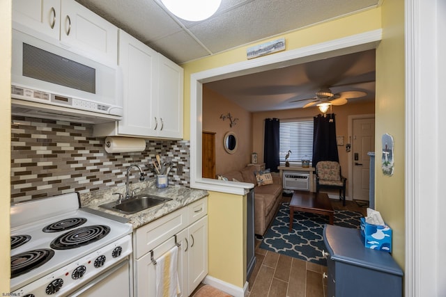 921 Wesley Ave Unit B21, Ocean City, NJ 08226 - kitchen with decorative backsplash, ceiling fan, a sink, white cabinets, and white appliances