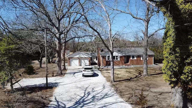 view of yard featuring driveway and a garage