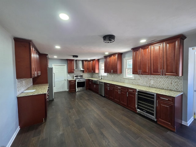 kitchen featuring wall chimney range hood, appliances with stainless steel finishes, tasteful backsplash, wine cooler, and recessed lighting