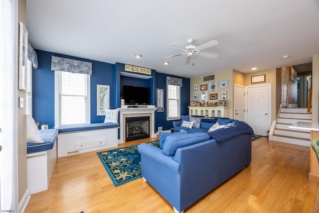 living area featuring a ceiling fan, recessed lighting, wood finished floors, and a fireplace