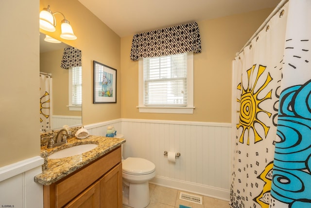 bathroom featuring visible vents, wainscoting, toilet, and vanity
