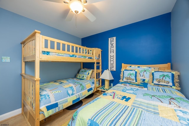 bedroom with baseboards, a ceiling fan, and wood finished floors