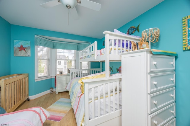 bedroom with baseboards, radiator heating unit, and wood finished floors