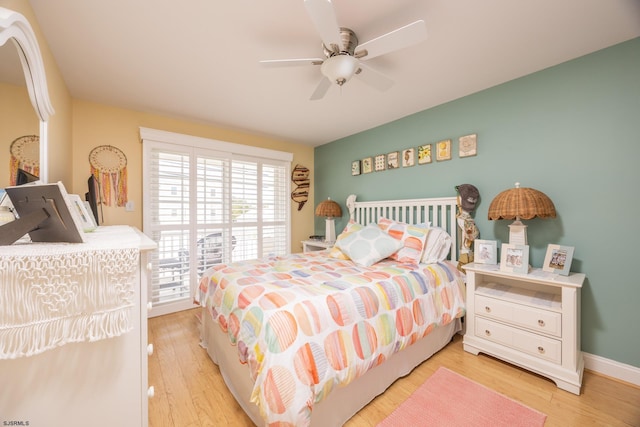 bedroom featuring baseboards, light wood finished floors, and ceiling fan