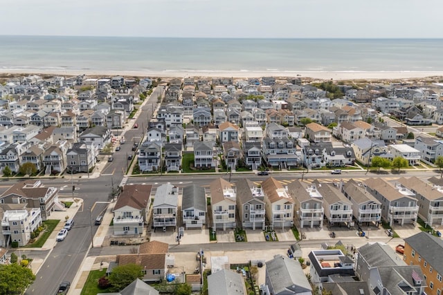 aerial view featuring a residential view, a view of the beach, and a water view