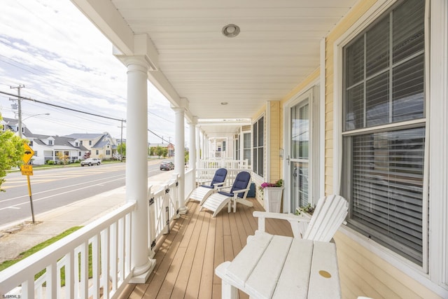 wooden deck featuring a residential view and a porch