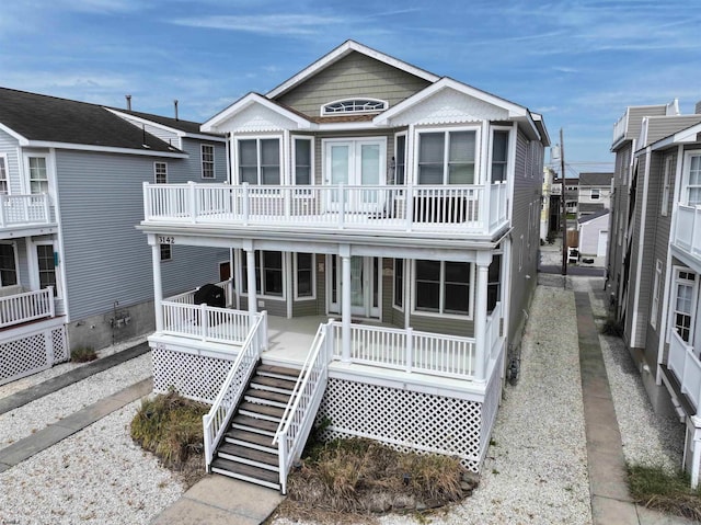 view of front of property with a porch, a balcony, and stairway
