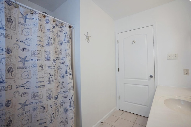 full bathroom with tile patterned flooring, a sink, baseboards, and a shower with shower curtain