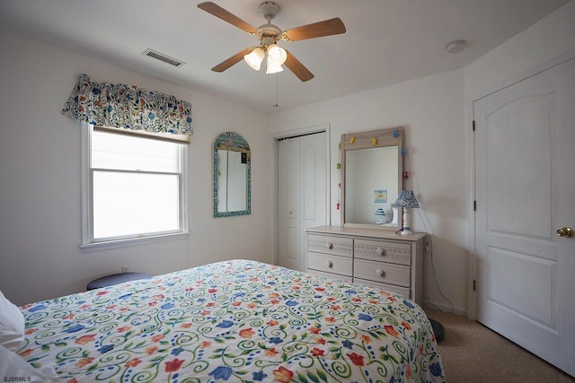 bedroom featuring visible vents, carpet floors, a closet, and ceiling fan