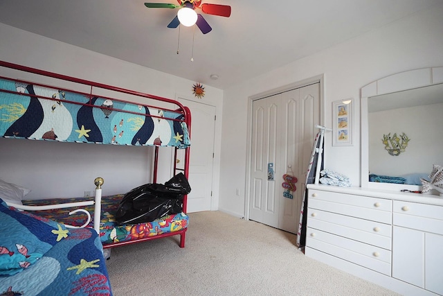 bedroom featuring ceiling fan, light carpet, and a closet