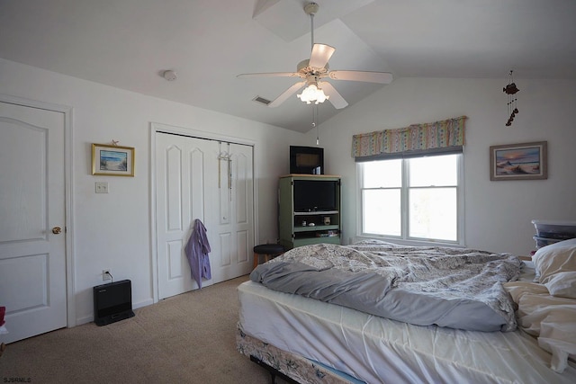bedroom featuring a closet, visible vents, a ceiling fan, carpet, and vaulted ceiling