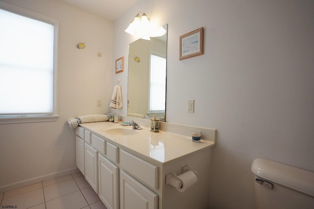 bathroom with toilet, baseboards, tile patterned flooring, and vanity