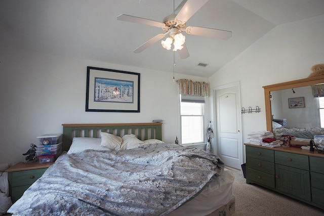 carpeted bedroom with visible vents, ceiling fan, and vaulted ceiling