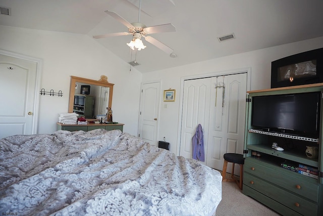 bedroom with visible vents, light carpet, lofted ceiling, and a closet