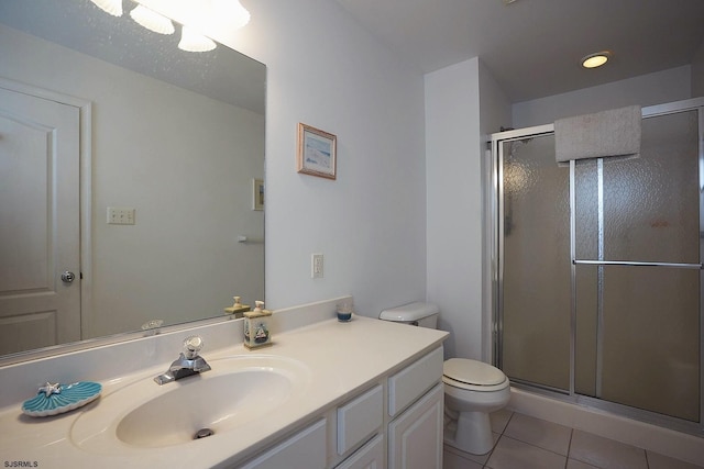 full bathroom with toilet, tile patterned floors, a shower stall, and vanity