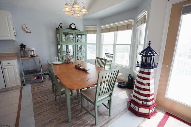dining area with an inviting chandelier and lofted ceiling