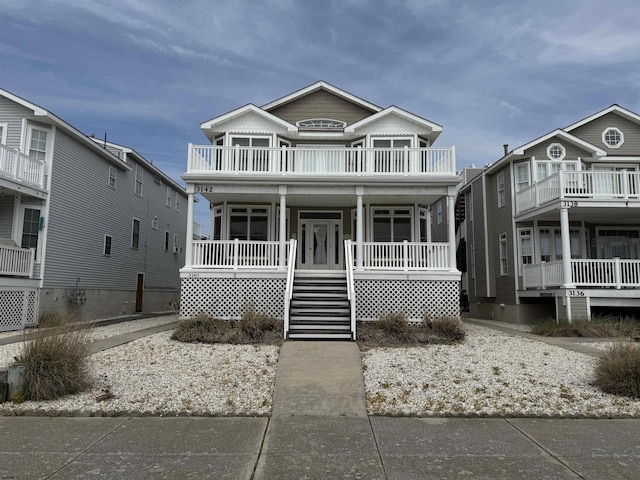 view of front of property with covered porch and a balcony