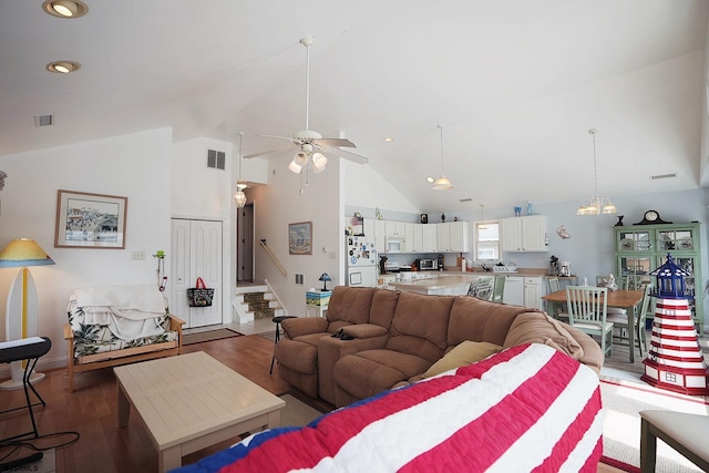 living area featuring stairway, ceiling fan, wood finished floors, and visible vents