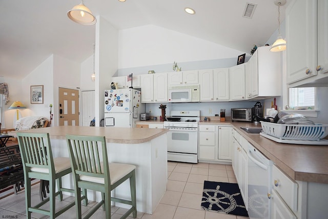 kitchen featuring a breakfast bar, white appliances, high vaulted ceiling, white cabinetry, and light tile patterned floors