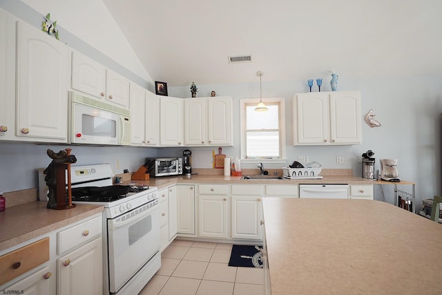 kitchen with a sink, white appliances, light tile patterned floors, vaulted ceiling, and visible vents
