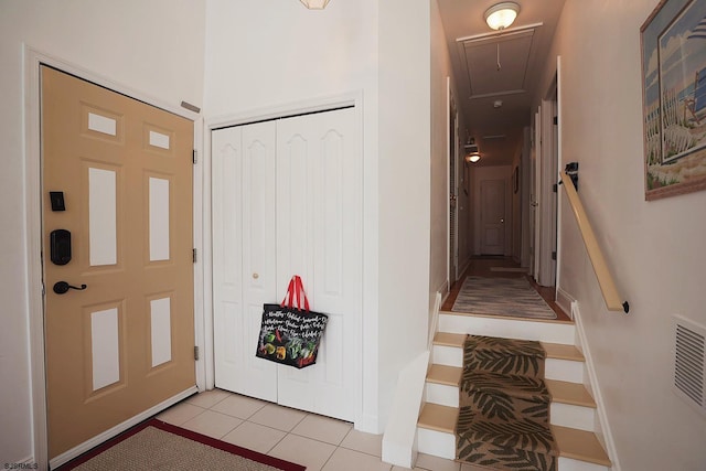 foyer entrance with light tile patterned floors, baseboards, and visible vents
