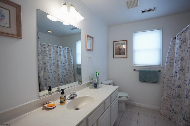 bathroom with tile patterned floors, visible vents, and plenty of natural light