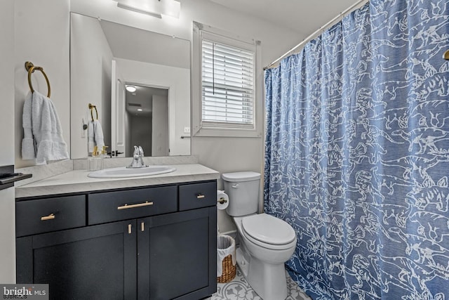 bathroom with toilet, tile patterned floors, and vanity