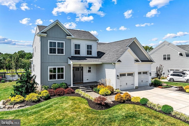 traditional-style house featuring board and batten siding, driveway, a front yard, a garage, and a shingled roof