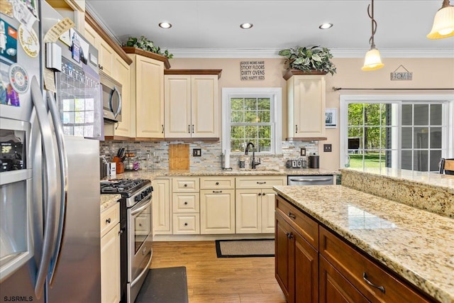 5905 Hickory St, Mays Landing, NJ 08330 - kitchen featuring appliances with stainless steel finishes, a sink, decorative backsplash, light wood finished floors, and healthy amount of natural light