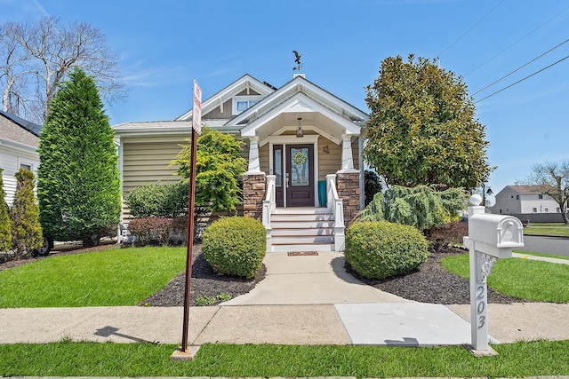 view of front of property featuring stone siding and a front lawn
