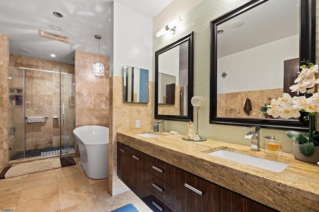 full bath featuring a sink, a soaking tub, and a stall shower
