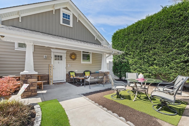 exterior space with board and batten siding and a porch
