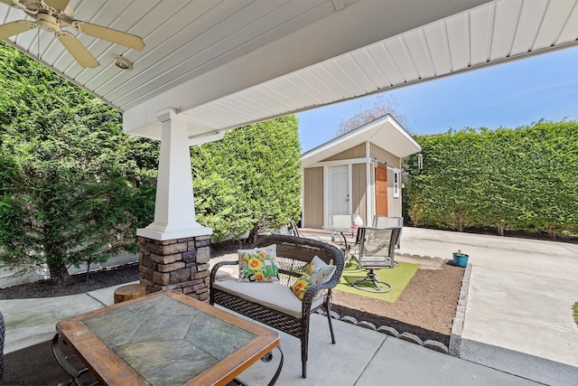 view of patio with a ceiling fan and an outdoor structure